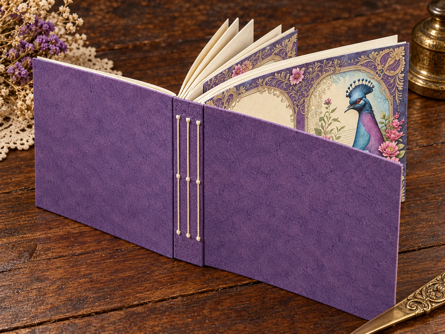 Purple designer-paper journal showing three separate lines of spine stitching and patterned inner pages.